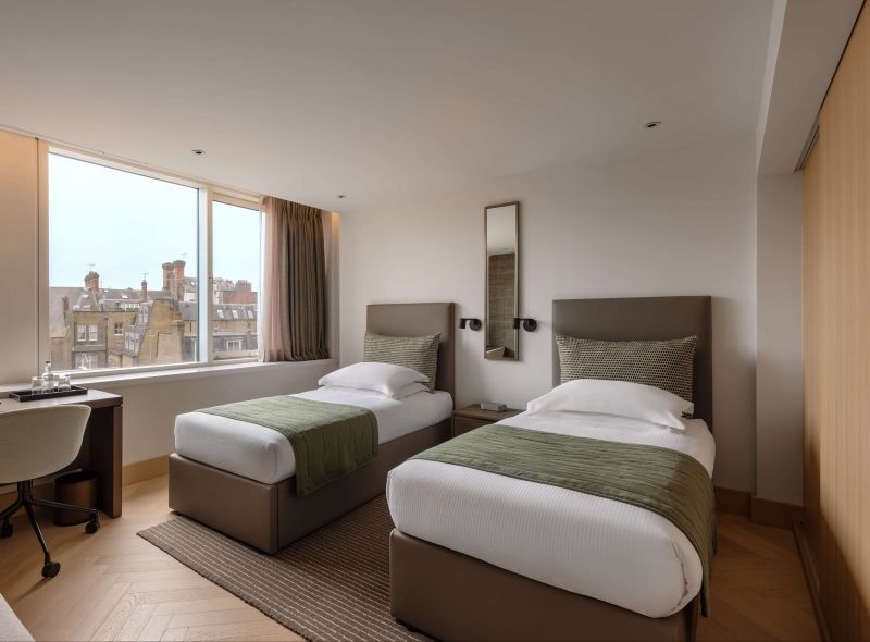 The newly refurbish and comfortable Deluxe Twin room at Royal Garden Hotel features separate twin beds and extra space.