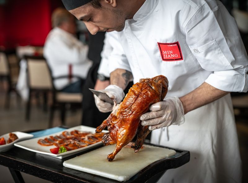 Min Jiang offers signature Wood-Fired Beijing Duck sliced on tableside.